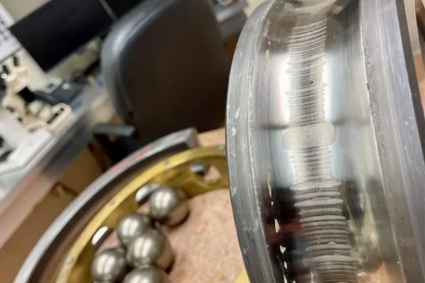 Close-up of bearing fluting damage caused by shaft voltage, illustrating why insulated bearing replacement is recommended for reliability.