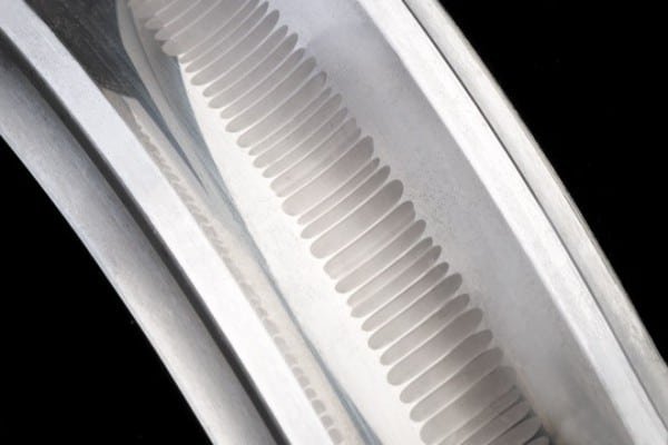 Close-up of a bearing raceway displaying the distinct rhythmic "washboard" grooves characteristic of electrical fluting damage.