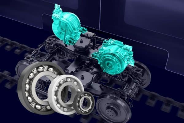 The undercarriage of a high-speed train showing the bogie and traction motor assembly, which requires insulated bearings for reliability.