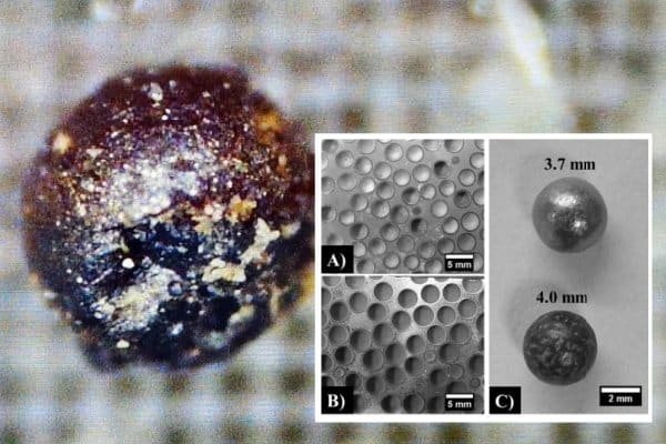 Microscopic ferrography image revealing perfect molten metal spheres in grease, the signature sign of electrical discharge machining (EDM).