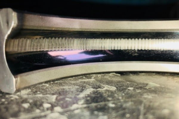 An inner bearing ring showing the rhythmic "tiger stripe" pattern typical of advanced electrical erosion damage.