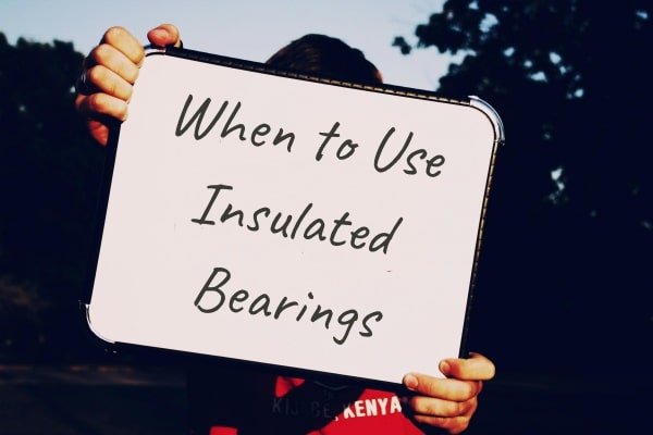 A conceptual illustration of an industrial facility highlighting motors that require insulated bearings versus standard bearings based on the 100 HP rule.